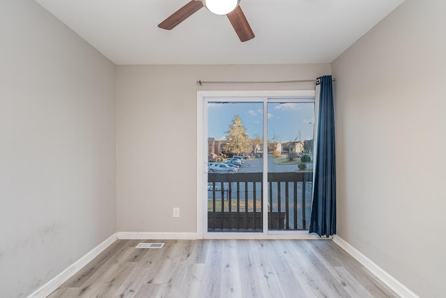 unfurnished room featuring light wood-type flooring and ceiling fan