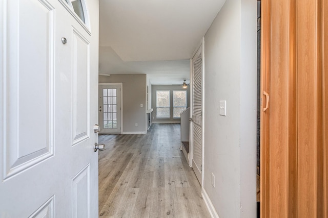 hallway with light hardwood / wood-style flooring