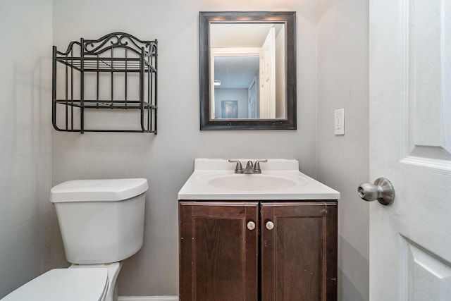 bathroom featuring toilet and vanity