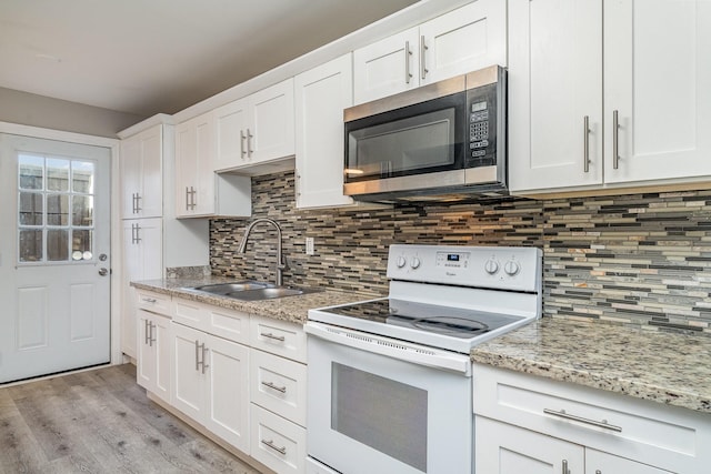 kitchen with sink, white cabinets, white range with electric cooktop, and tasteful backsplash