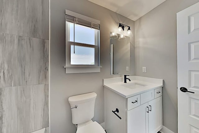 bathroom featuring toilet and vanity