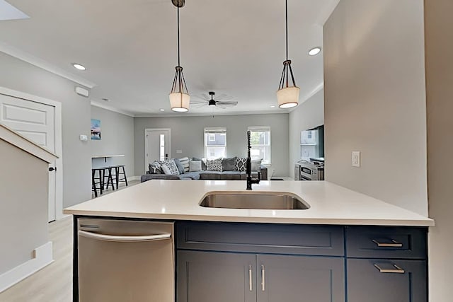 kitchen featuring sink, dishwasher, gray cabinets, and decorative light fixtures