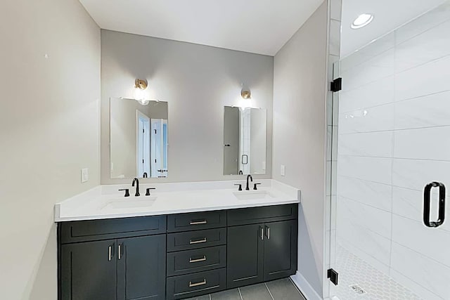 bathroom featuring walk in shower, vanity, and tile patterned flooring