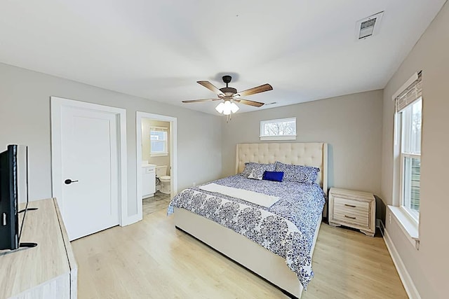 bedroom with ceiling fan, connected bathroom, and light wood-type flooring