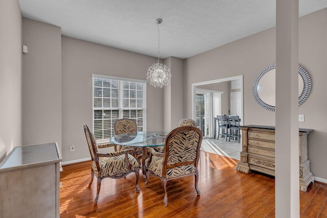 dining room featuring hardwood / wood-style flooring and an inviting chandelier