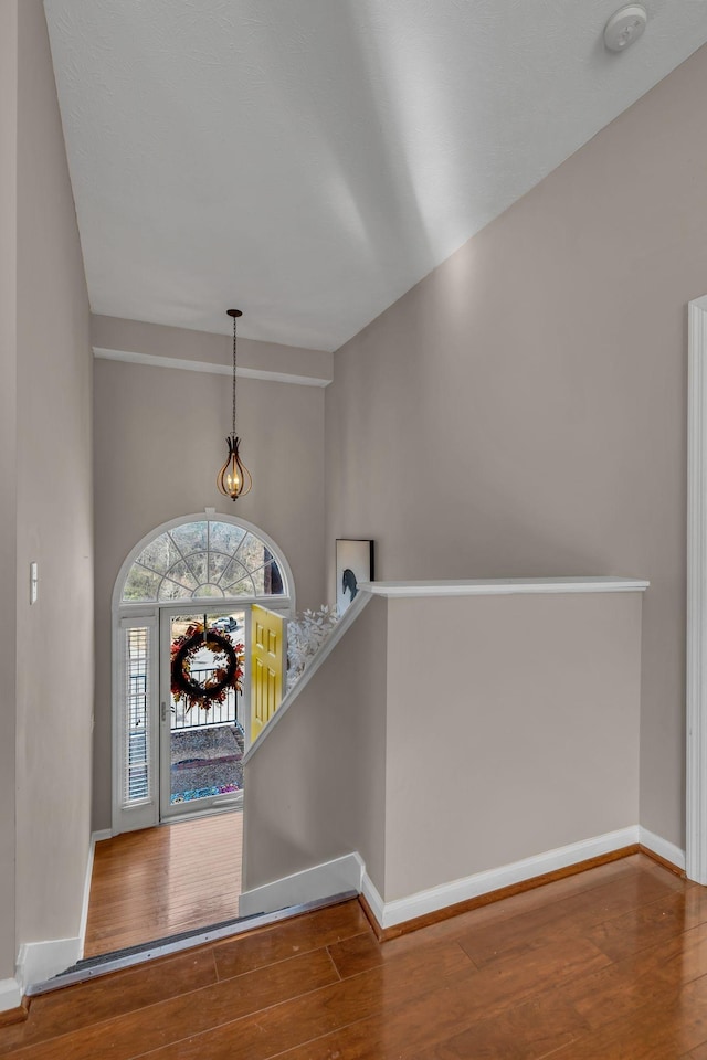 entryway featuring hardwood / wood-style flooring and vaulted ceiling