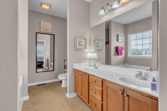 bathroom featuring vanity, toilet, and a bathing tub