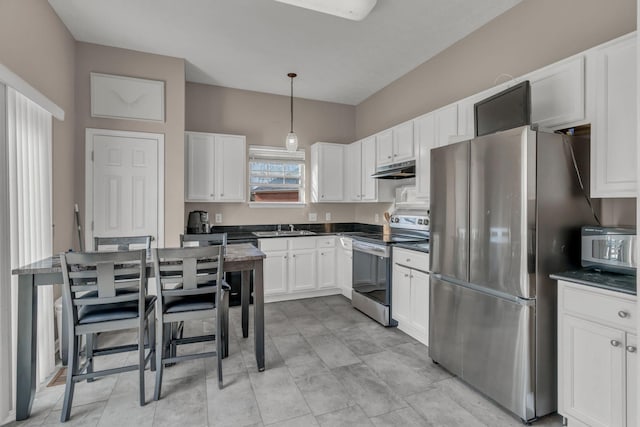 kitchen with white cabinets, hanging light fixtures, appliances with stainless steel finishes, and sink