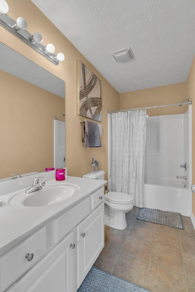 full bathroom with shower / tub combo, tile patterned floors, toilet, a textured ceiling, and vanity