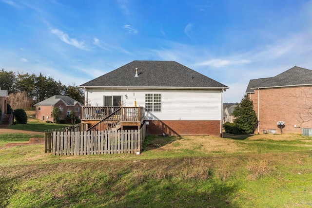 back of house with a lawn and a wooden deck