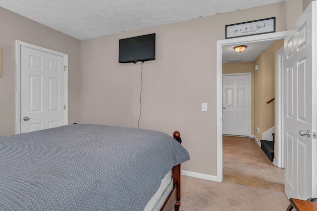 tiled bedroom with a textured ceiling