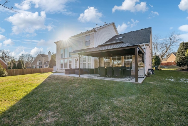 rear view of house with a patio area and a lawn