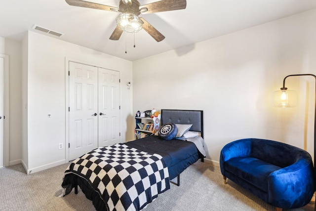 bedroom with light carpet, a closet, and ceiling fan