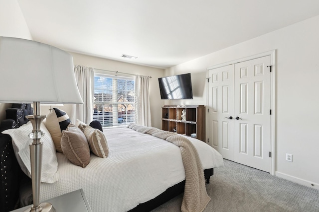 bedroom with light colored carpet and a closet