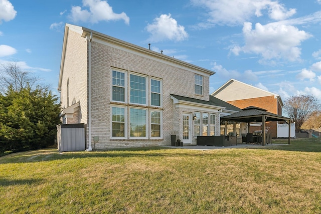 back of property featuring a patio area, a gazebo, and a yard