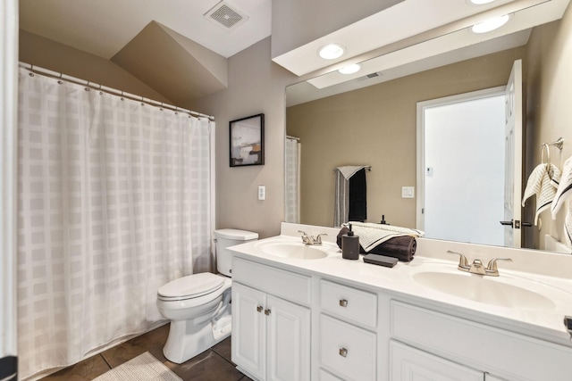 bathroom with tile patterned floors, vanity, and toilet