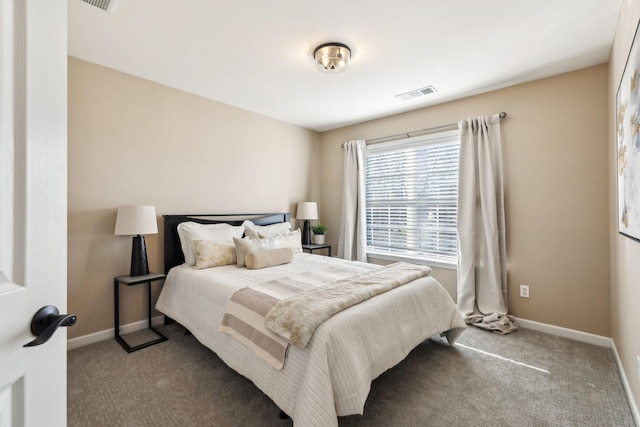 bedroom with dark colored carpet