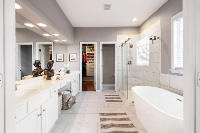 bathroom with tile patterned floors, vanity, and independent shower and bath