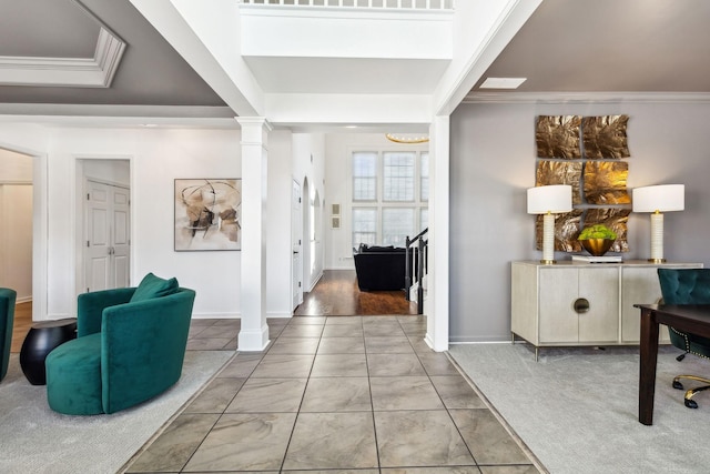 entryway featuring decorative columns, carpet flooring, and ornamental molding