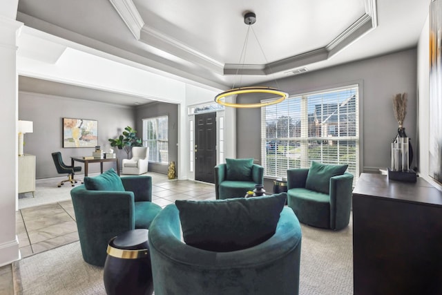 tiled living room featuring plenty of natural light, a tray ceiling, and ornamental molding