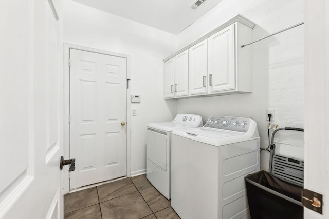 washroom featuring independent washer and dryer, cabinets, and tile patterned flooring