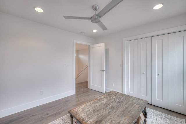 bedroom with ceiling fan, a closet, and light wood-type flooring