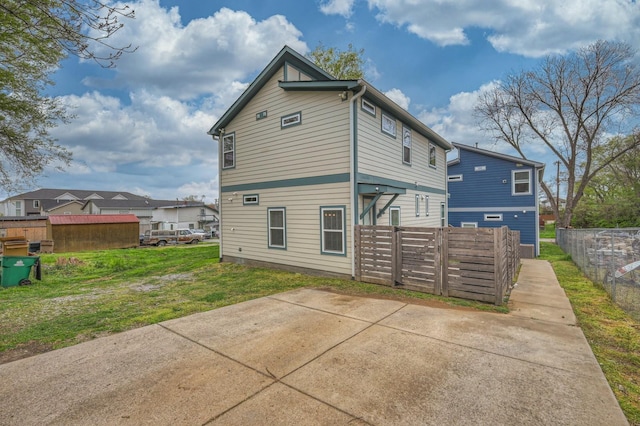 back of property featuring a lawn and a patio