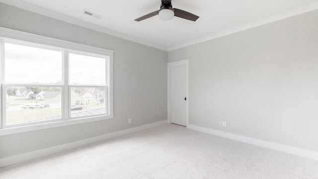 spare room with plenty of natural light, carpet flooring, ceiling fan, and ornamental molding