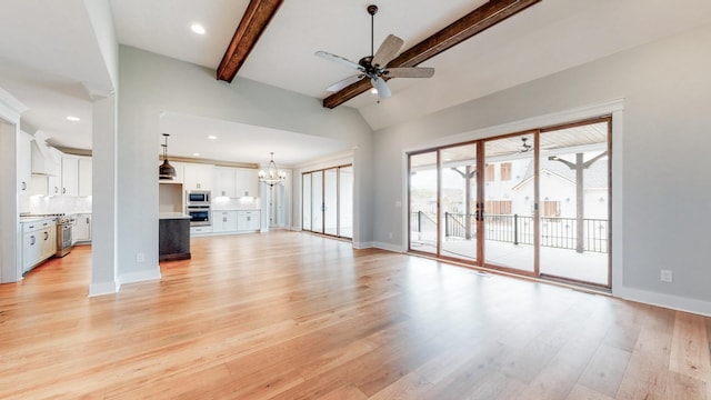 unfurnished living room with ceiling fan with notable chandelier, light hardwood / wood-style flooring, and lofted ceiling with beams