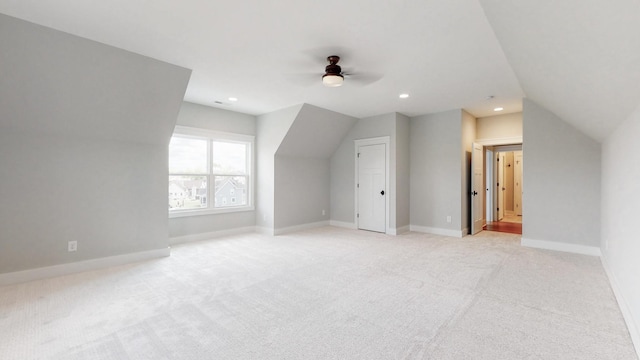 additional living space with ceiling fan, light carpet, and vaulted ceiling