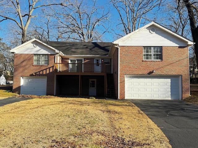 view of front facade featuring a garage, a front lawn, and a wooden deck