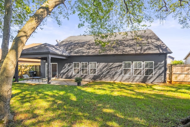 rear view of property with a patio area and a yard