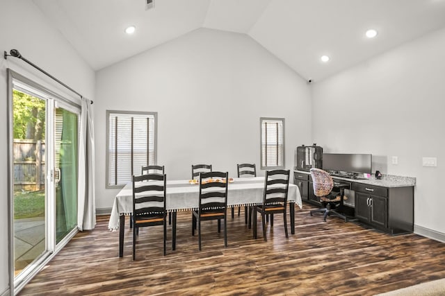 dining room featuring dark wood-type flooring and high vaulted ceiling