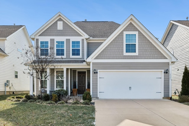 craftsman-style house with a porch, a garage, and a front yard