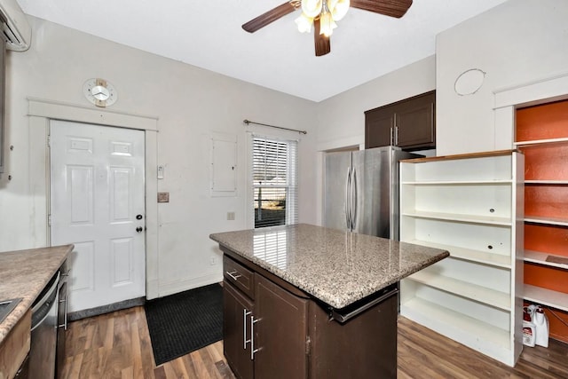 kitchen with an AC wall unit, a kitchen island, stainless steel appliances, dark hardwood / wood-style floors, and dark brown cabinets