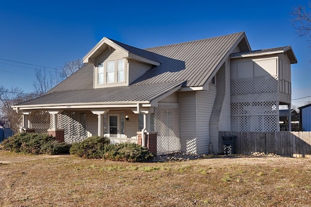 view of front of home with a porch and a front lawn