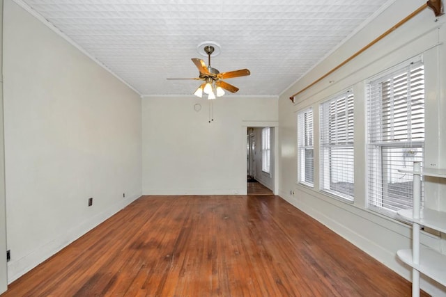 unfurnished room with ceiling fan, dark hardwood / wood-style floors, and ornamental molding