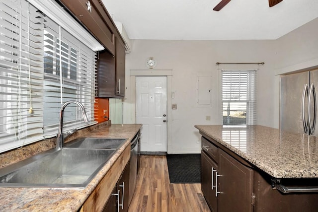 kitchen featuring dark brown cabinetry, appliances with stainless steel finishes, sink, dark hardwood / wood-style floors, and ceiling fan