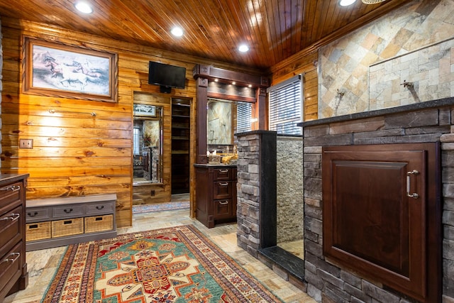 interior space with vanity, wooden ceiling, and wooden walls