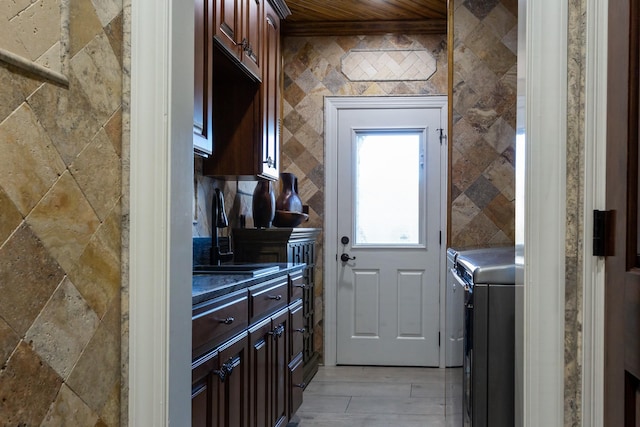 kitchen with sink, wooden ceiling, and washing machine and clothes dryer