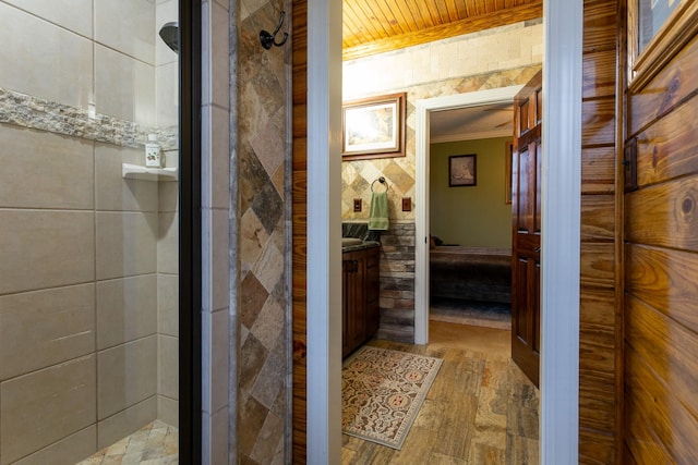 bathroom with a shower with door, vanity, ornamental molding, and wooden ceiling