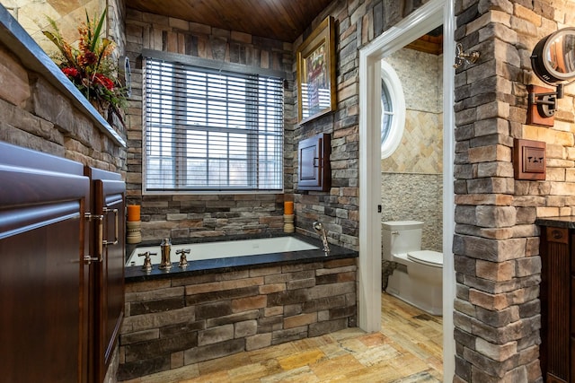 bathroom featuring wooden ceiling, a tub, and toilet