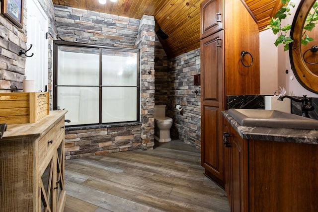 bathroom with lofted ceiling, vanity, wood-type flooring, wooden ceiling, and toilet