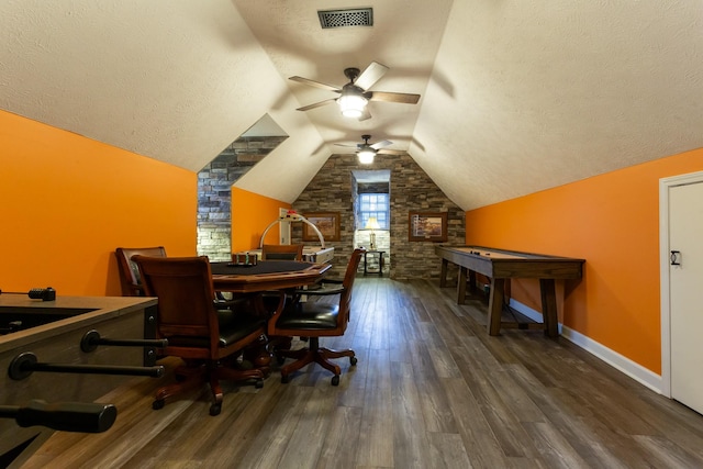 interior space featuring ceiling fan, lofted ceiling, dark hardwood / wood-style flooring, and a textured ceiling