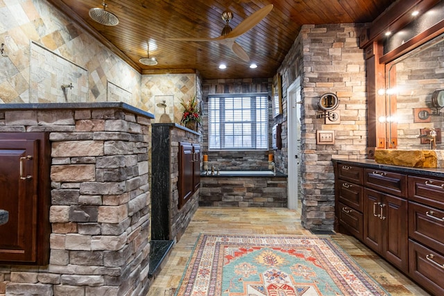 bathroom featuring vanity, wood ceiling, a stone fireplace, and independent shower and bath