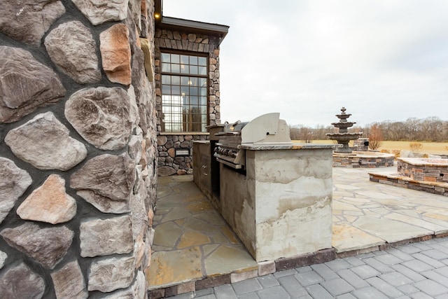 view of patio with a grill and exterior kitchen