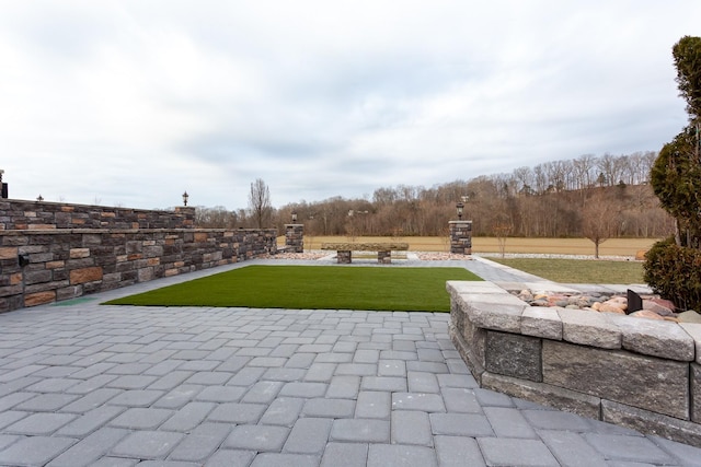 view of patio with an outdoor fire pit