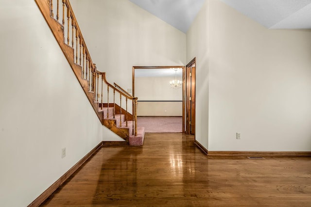 foyer entrance featuring a chandelier and dark hardwood / wood-style flooring