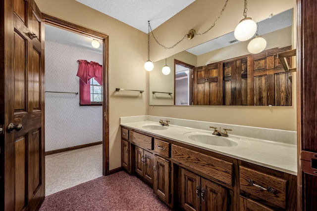 bathroom featuring a textured ceiling and vanity