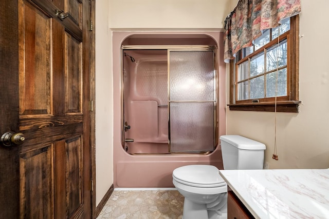 full bathroom with combined bath / shower with glass door, vanity, and toilet